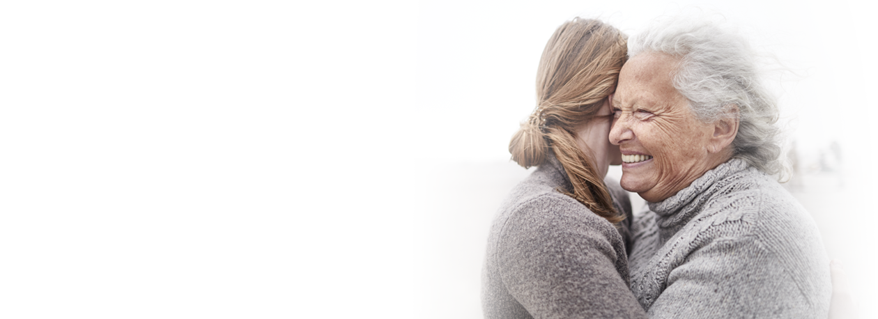 Older Woman and Girl Hugging Beach